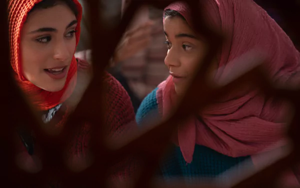 HD desktop wallpaper of Kamala Khan from the TV show Ms. Marvel — two girls in headscarves sharing a warm, attentive moment.