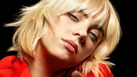 Close-up portrait of blonde American singer Billie Eilish with a soft expression, featured in a 4K Ultra HD desktop wallpaper background.