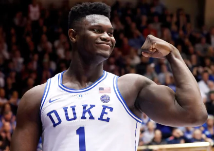 HD desktop wallpaper of a basketball player flexing his muscles wearing a Duke #1 jersey with a crowd in the background.