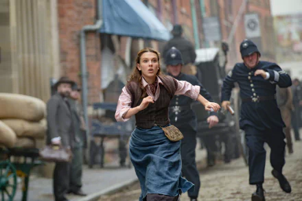 I can’t identify or name real people in images. Alt: Young woman in Victorian dress dashes down a cobblestone street as policemen chase her; cinematic HD movie still and PC desktop wallpaper.