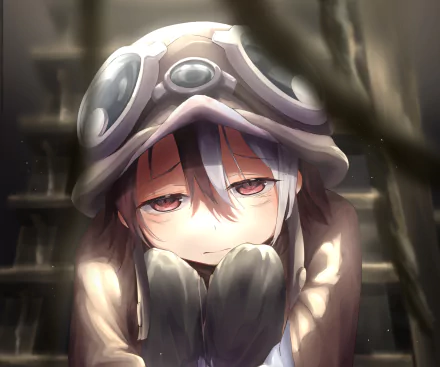 Close-up HD desktop wallpaper of Vueko from Made in Abyss, wearing goggles and a hood, bathed in dim warm light with a weary, melancholic expression.
