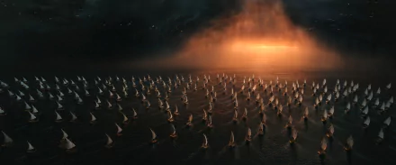 2K Quad HD PC desktop wallpaper from TV show The Lord of the Rings: The Rings of Power — countless small sailboats crossing a dark sea toward an ominous orange fire-glow on the horizon.