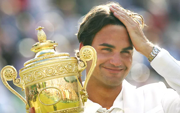 Roger Federer, the Swiss tennis champion, in action on a vibrant, high-resolution desktop wallpaper, showcasing his prowess and skill in the sport.