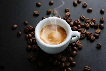 HD PC desktop wallpaper: steaming espresso cup on a dark surface with scattered coffee beans, a food/coffee scene.