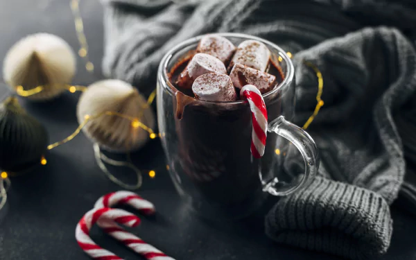 A cozy desktop wallpaper featuring a delicious cup of hot chocolate topped with marshmallows, perfect for winter vibes.