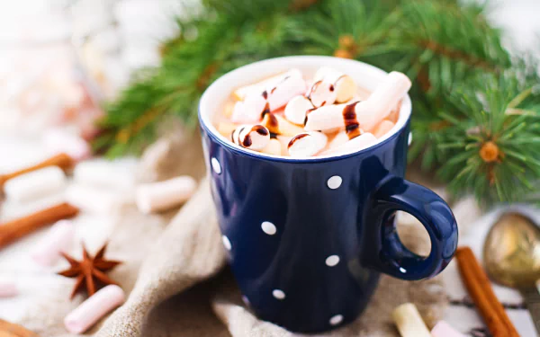 A warm cup of hot chocolate filled with marshmallows, perfect for a cozy desktop wallpaper.