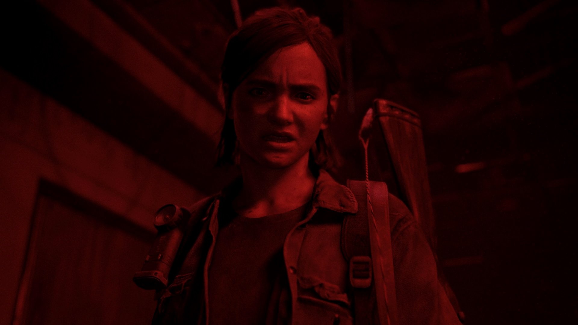 Ellie (The Last of Us) in red lighting, tense with a backpack and weapon over her shoulder — 4K Ultra HD PC desktop wallpaper.