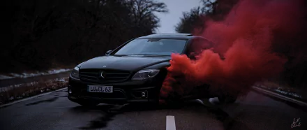 HD PC desktop wallpaper featuring a sleek black car on a dark road with vibrant red smoke billowing from its side, surrounded by trees in the background.