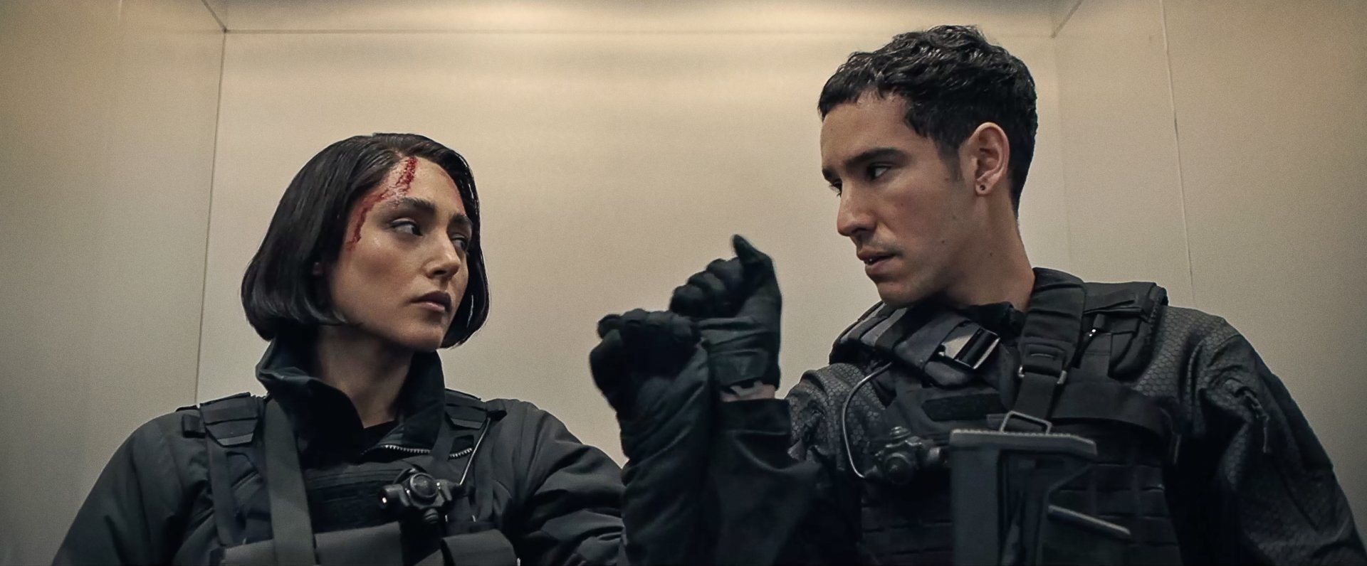 A dramatic scene from Extraction 2 featuring Adam Bessa and Golshifteh Farahani, showcasing intense expressions while dressed in tactical gear. HD desktop wallpaper.