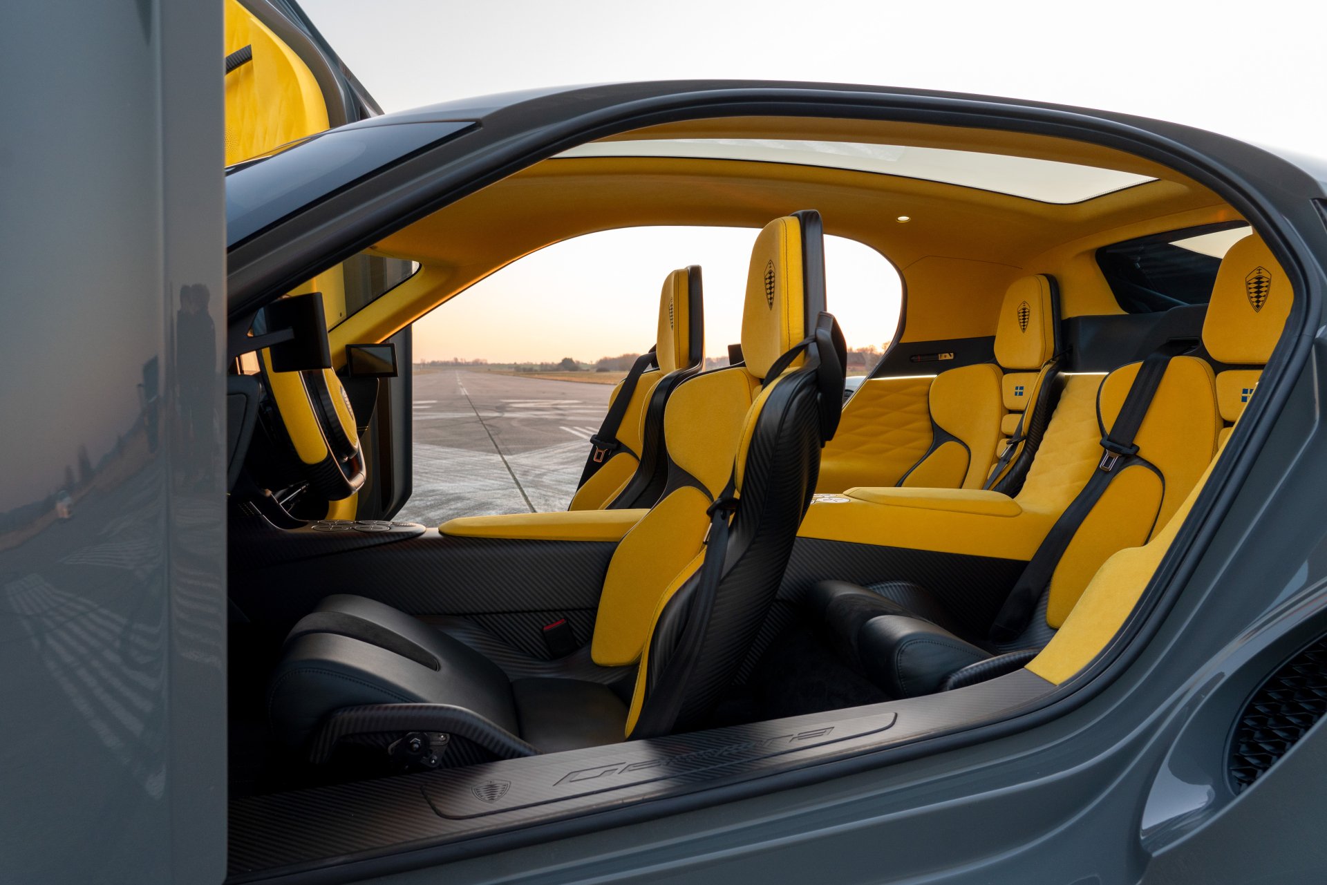 Koenigsegg Gemera interior showing luxurious yellow seats, serving as a high-definition desktop wallpaper.