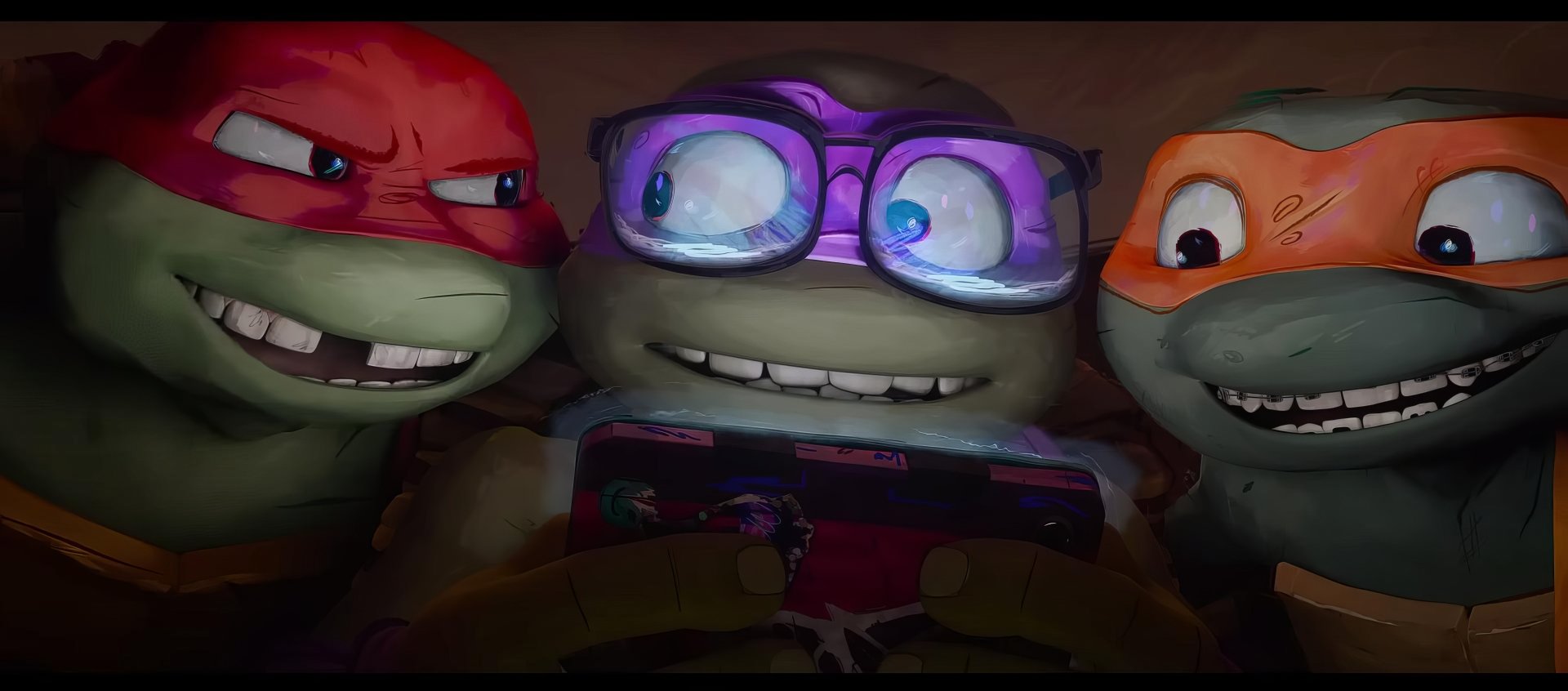 Three Teenage Mutant Ninja Turtles share a joyful moment, engrossed in a game on a phone. This vibrant image from Teenage Mutant Ninja Turtles: Mutant Mayhem serves as an engaging HD desktop wallpaper.