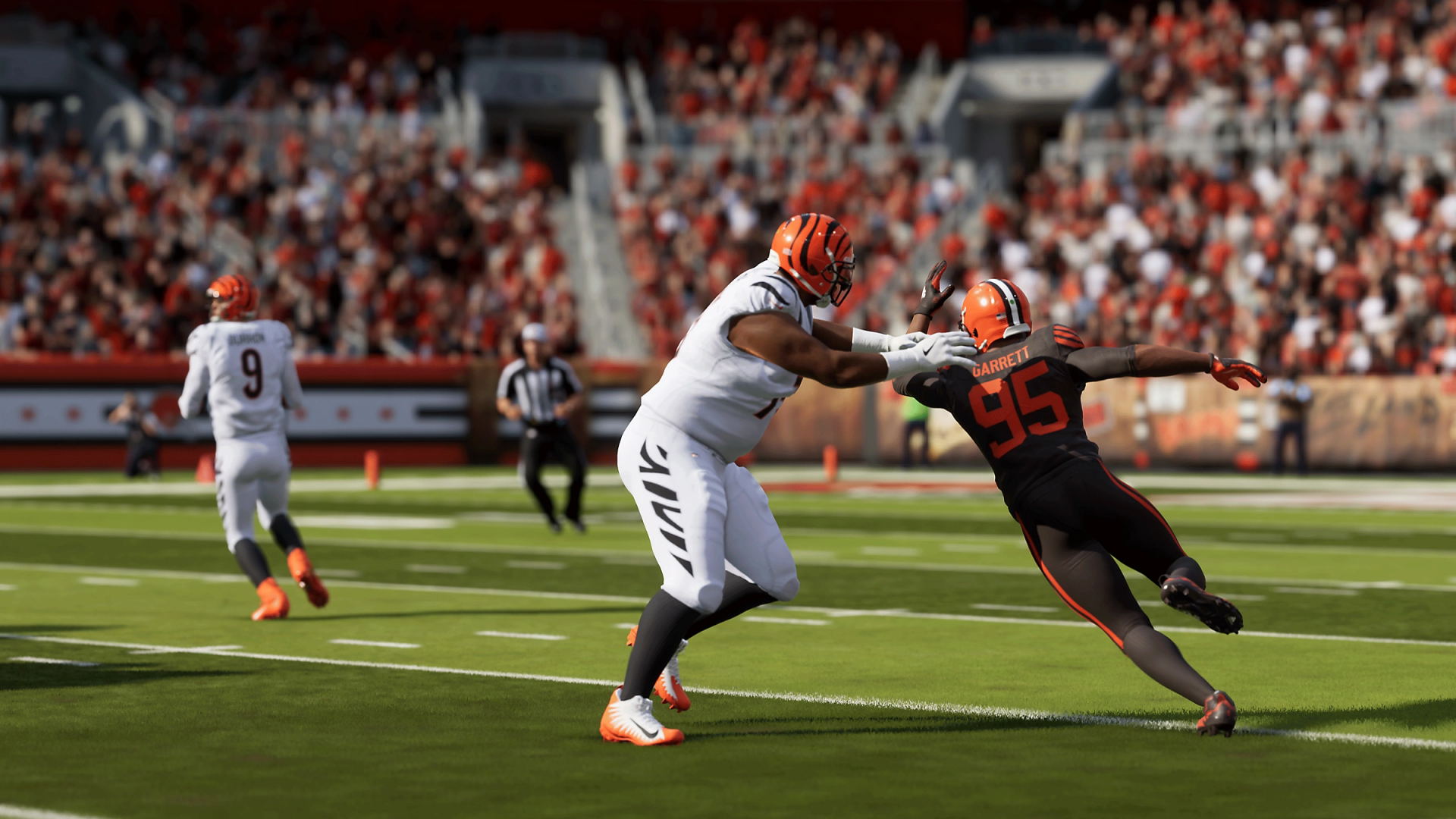 HD desktop wallpaper from Madden NFL 24 featuring a dynamic in-game scene of two football players in the midst of a tackle at a crowded stadium.