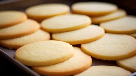 Close-up of freshly baked sugar cookies on a tray for HD desktop wallpaper.