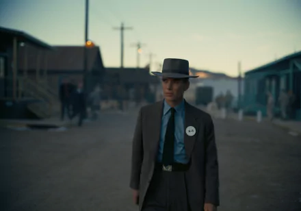 HD desktop wallpaper featuring a historical drama theme with a suited character standing in a vintage setting, evoking the movie Oppenheimer.