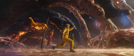 A scene from Guardians of the Galaxy Vol. 3, featuring characters in vibrant costumes navigating a surreal, colorful environment filled with tentacles and glowing elements.