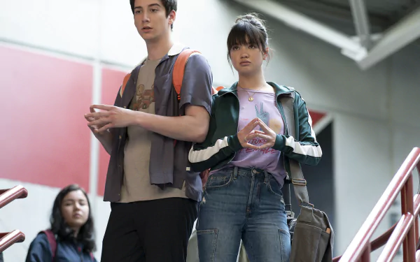 HD desktop wallpaper featuring two teenagers walking down the stairs from the movie Prom Pact, embodying a high school scene.