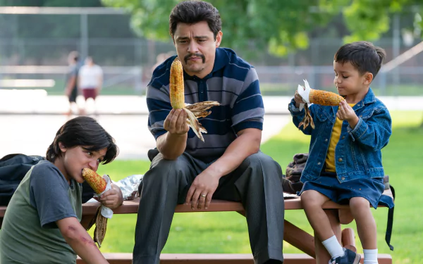 Family enjoying corn on the cob at a park on a sunny day, a perfect Flamin' Hot themed HD desktop wallpaper and background.