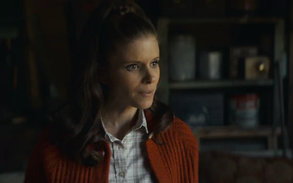 HD desktop wallpaper featuring a scene from Black Mirror with a woman in an orange cardigan and white shirt, exuding a contemplative expression, set in a dimly lit, vintage-style room.