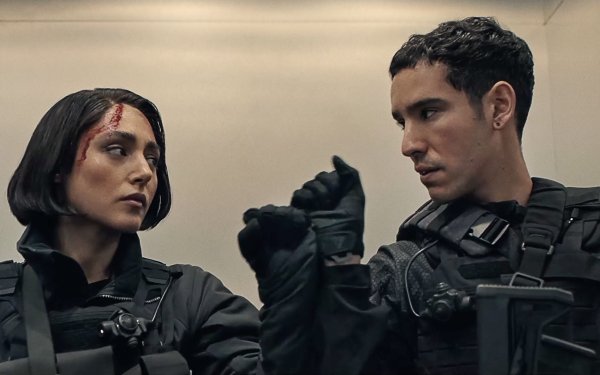 HD wallpaper featuring two actors in tactical gear looking intently at something off-camera, tagged with Extraction 2, ideal for a desktop background.