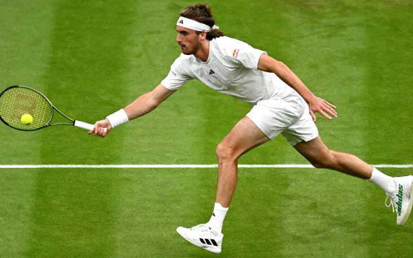Stefanos Tsitsipas in action at Wimbledon 2023, showcasing his athleticism and skill on the tennis court in this dynamic HD wallpaper.