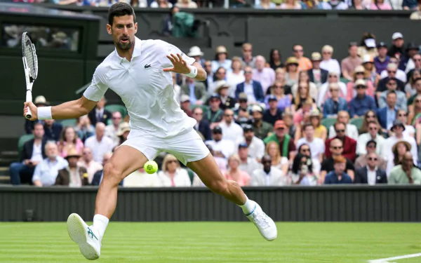HD wallpaper featuring a professional male tennis player in action during the Wimbledon 2023 tournament, showcasing dynamic on-court movement.