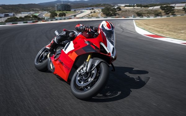 Red Ducati Panigale V4 R motorcycle speeding on a racetrack, ideal for HD desktop wallpaper and background.