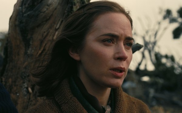 HD wallpaper featuring a still from the film Oppenheimer with Emily Blunt portraying a character, set against a natural backdrop, perfect for a desktop background.