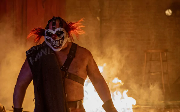 Person in a Twisted Metal-themed costume with a clown mask and flames in the background - HD wallpaper.