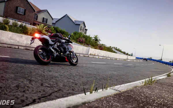 HD desktop wallpaper from the video game Ride 5, featuring a sport motorcycle racing on a suburban street.