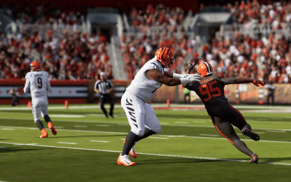 HD desktop wallpaper from Madden NFL 24 featuring a dynamic in-game scene of two football players in the midst of a tackle at a crowded stadium.