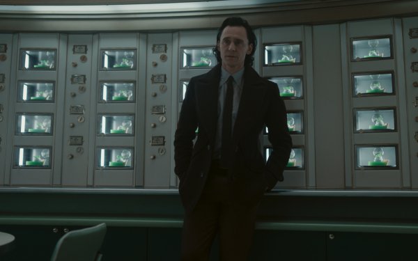 HD wallpaper featuring a character from Loki Season 2 standing in a room with multiple screens, perfect for desktop and background use, capturing the essence of Loki (Marvel Comics).