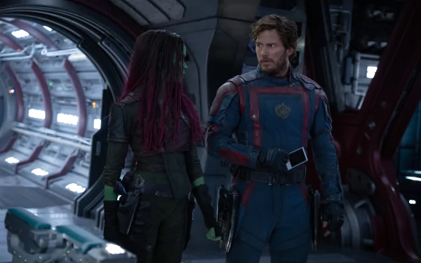 Star-Lord and Gamora from Guardians of the Galaxy Vol. 3 stand together inside a spaceship, showcasing their dynamic partnership in this HD wallpaper.