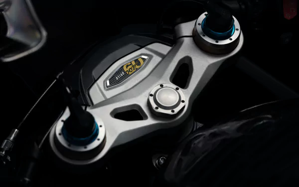 Close-up HD wallpaper of the Triumph Speed Triple 1200 RR Bond Edition motorcycle's top yoke with premium branding details and sleek design.