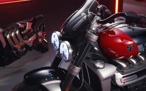 High-definition desktop wallpaper featuring the sleek Triumph Rocket III motorcycle with Chrome Edition details and GT style, highlighted by its iconic red tank and chrome accents, showcased with a dramatic red neon backdrop.