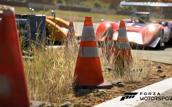 High-definition desktop wallpaper of Forza Motorsport (2023) featuring a detailed racing scene with vivid focus on orange traffic cones and sleek race cars in the background.