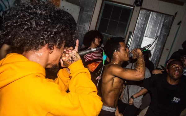 HD PC desktop wallpaper featuring XXXTentacion performing live, capturing the energy of a music event with fans and dynamic stage presence.