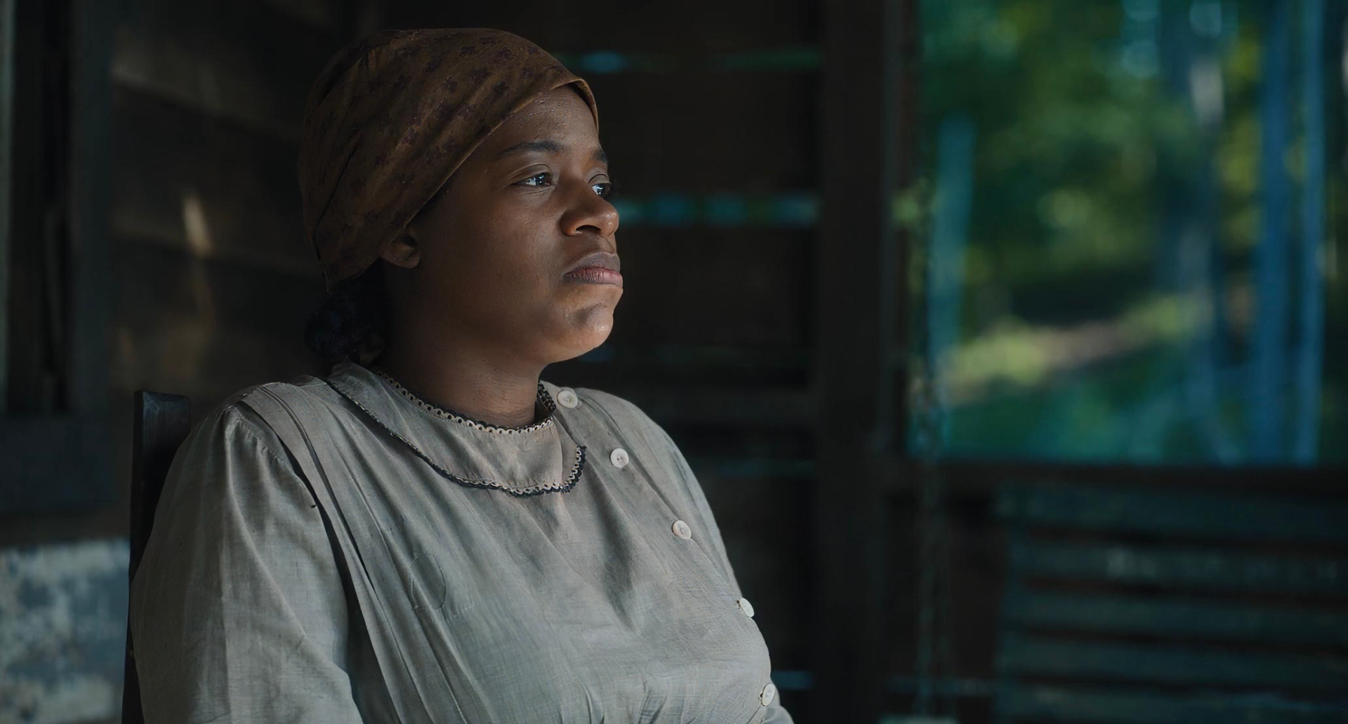 HD desktop wallpaper of a character from the 2023 movie The Color Purple, featuring a thoughtful expression in a vintage setting.