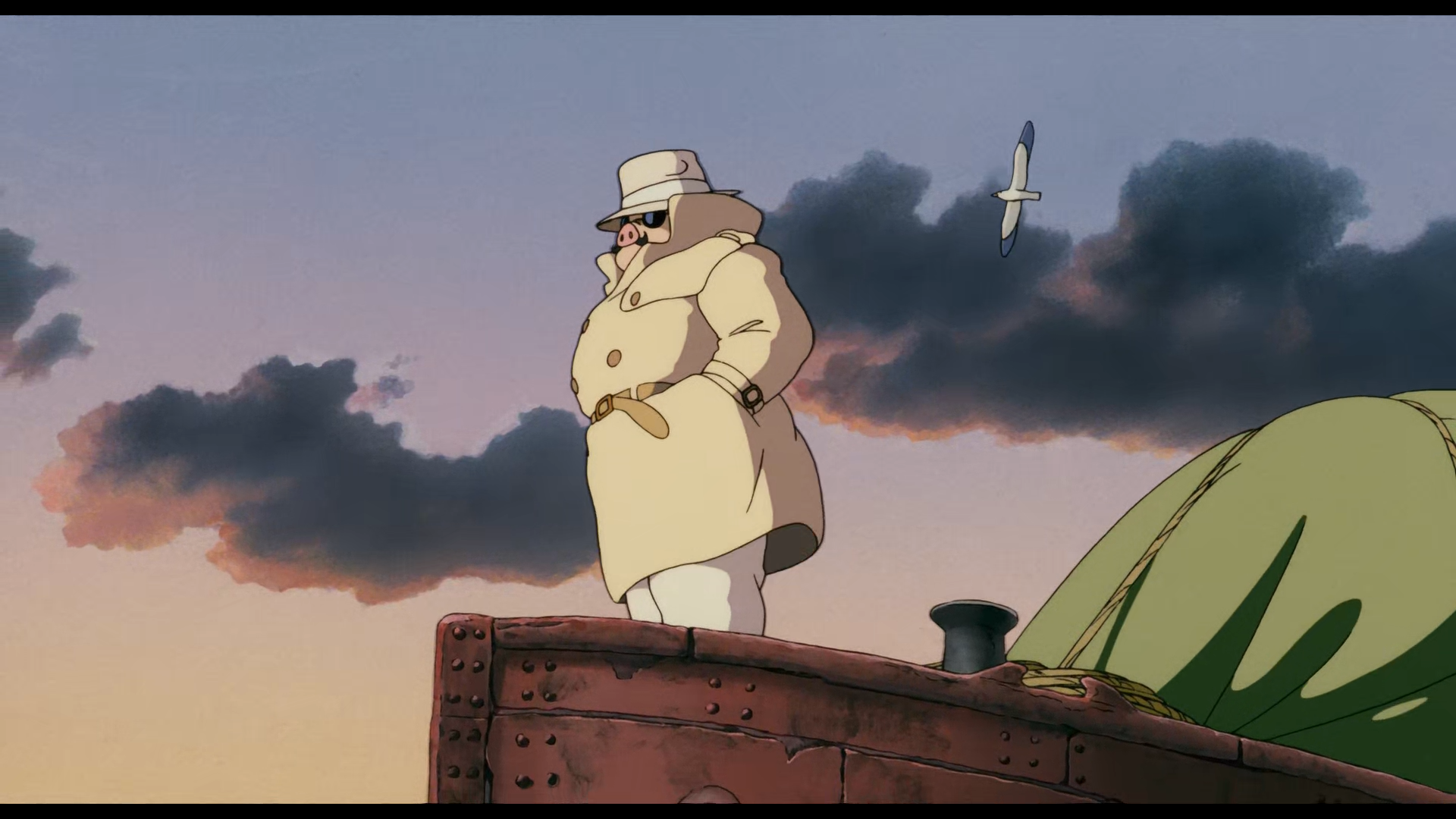HD PC desktop wallpaper of Porco Rosso by Studio Ghibli, featuring the iconic pig-headed pilot standing on a ship against a dramatic sky with a seagull flying nearby.