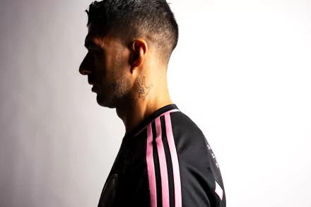Luis Suárez is featured in profile, wearing an Inter Miami CF jersey, against a clean white background. This HD image captures the essence of sports and dedication.