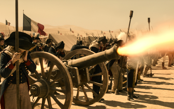 HD wallpaper of a Napoleonic era battle scene with soldiers firing a cannon, suitable for a historically themed desktop background.