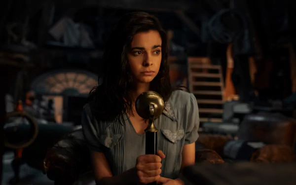 HD wallpaper featuring a scene from the TV show All the Light We Cannot See with a female character holding a microphone in a dimly lit room.