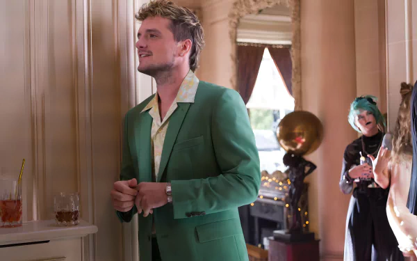 HD wallpaper of Josh Hutcherson in The Beekeeper movie, styled in a green suit at a social event setting.
