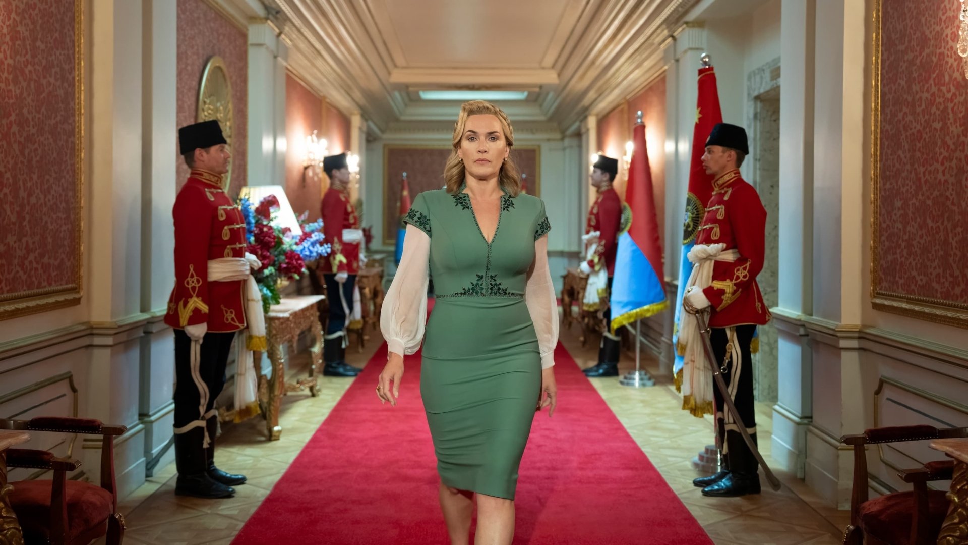 Kate Winslet walking down a red carpet in a scene from The Regime TV show, available as an HD desktop wallpaper.
