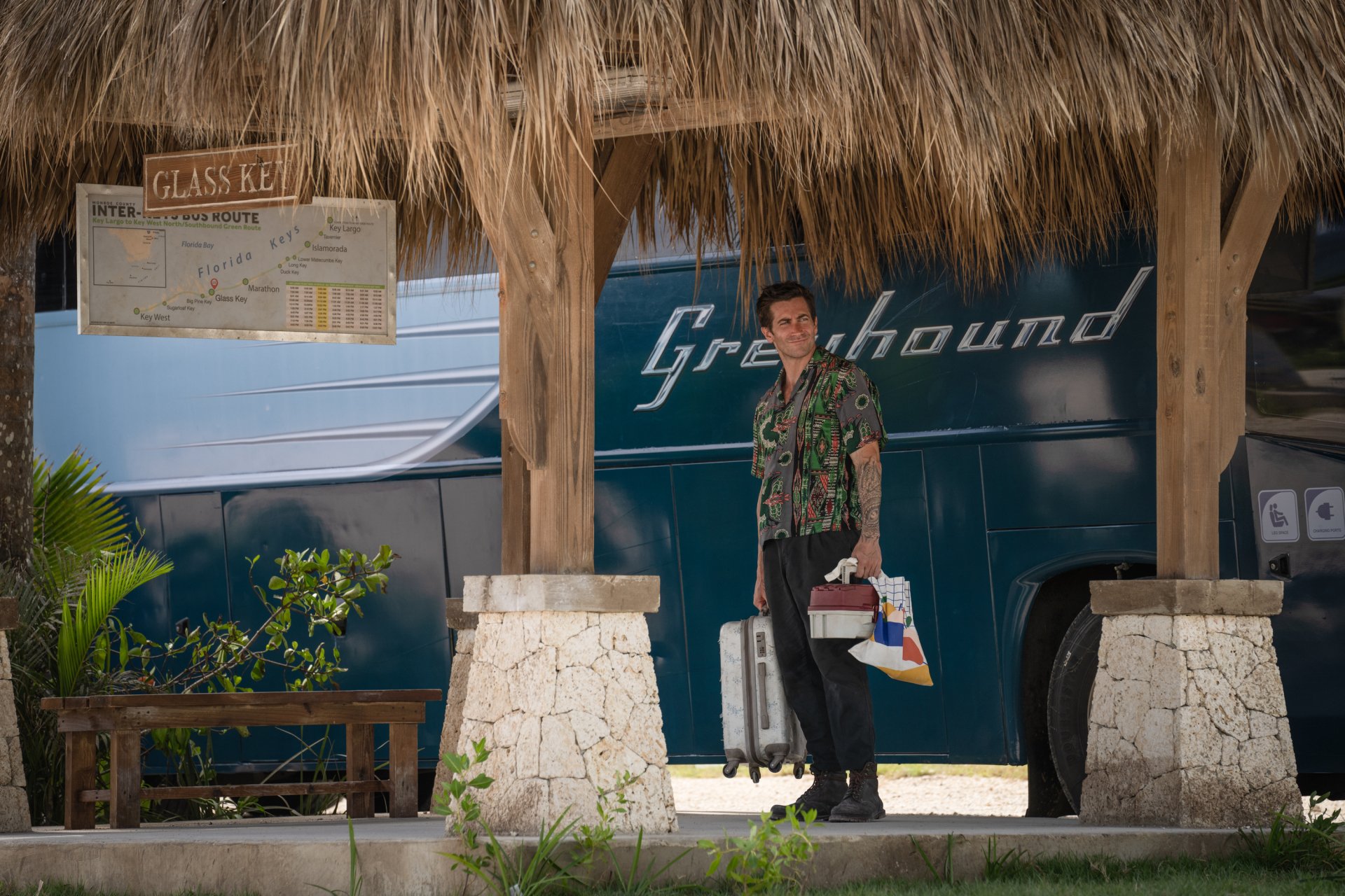 HD wallpaper featuring a scene from the 2024 movie Road House with a character standing in front of a Greyhound bus.