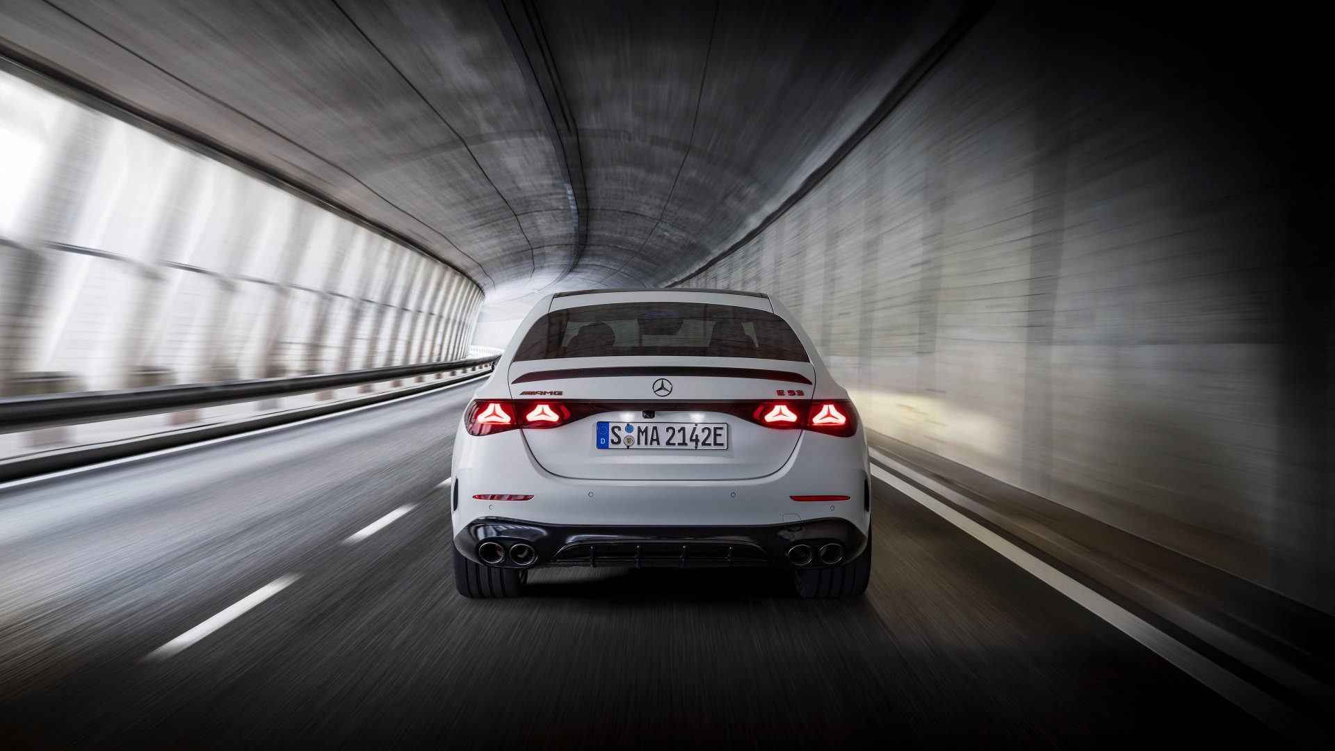 A Mercedes-AMG E53 Hybrid car speeds through a tunnel, captured as an HD desktop wallpaper.