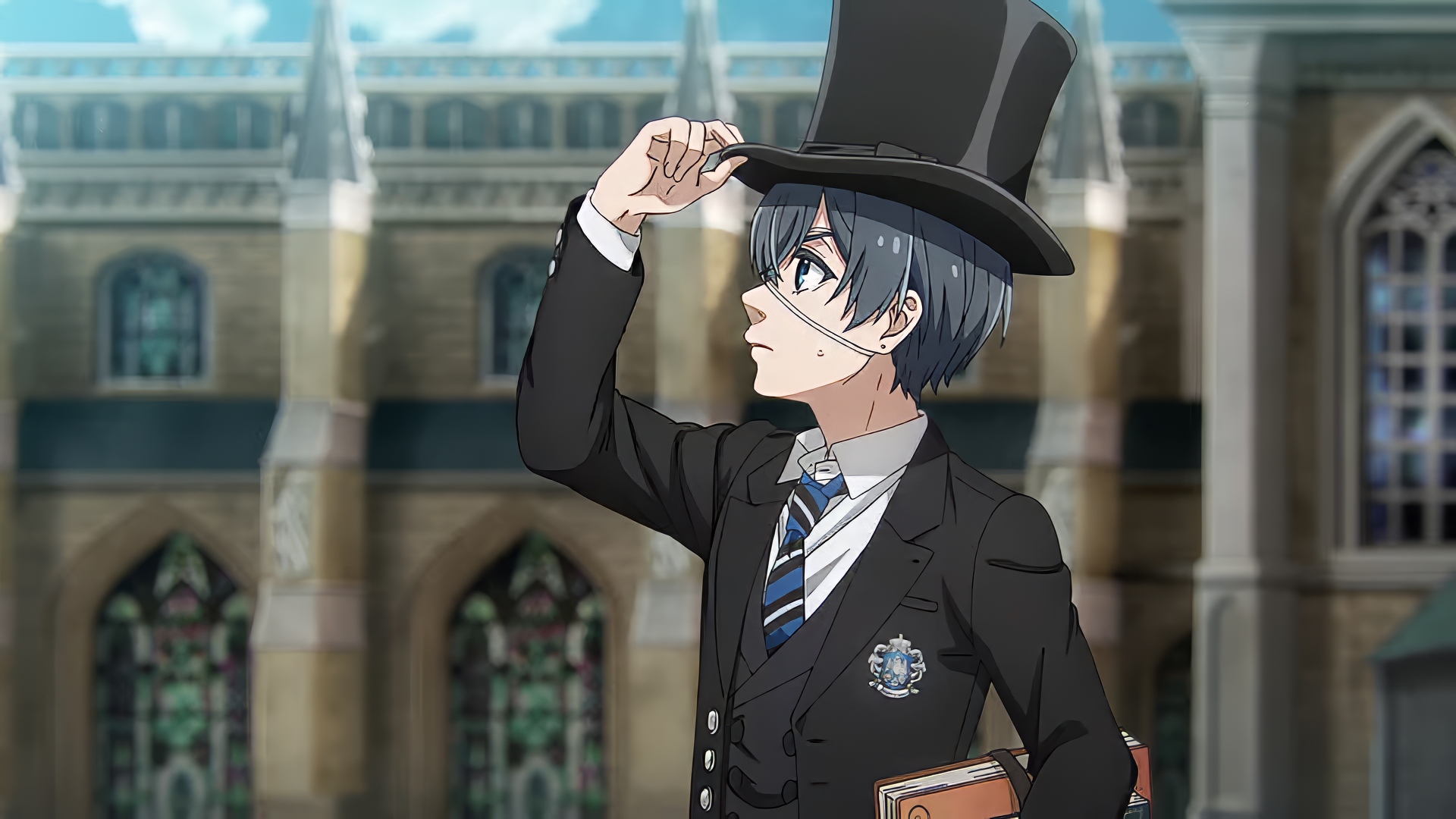 Animated character Ciel Phantomhive from Black Butler tipping his top hat, standing before an ornate building, in a high-definition desktop wallpaper.