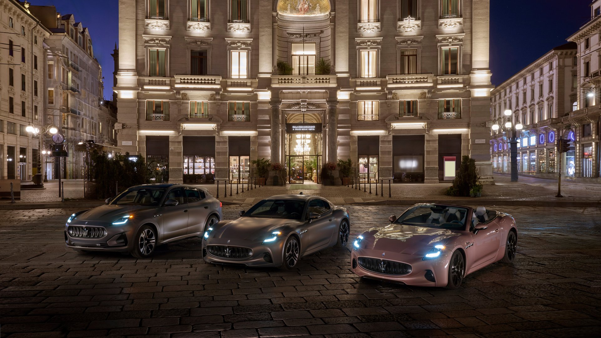 Three Maserati GranCabrio cars in different colors parked in front of an elegant building at nighttime, suitable as a high-definition desktop wallpaper or background.