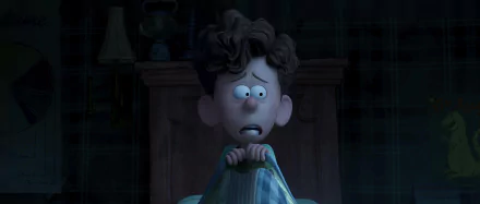 A young boy, frightened and wide-eyed, clutches his blanket in the dark, captured in a scene from the movie Orion and the Dark. This image serves as a striking HD wallpaper background.