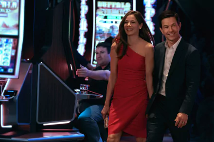 HD wallpaper from The Family Plan featuring a couple smiling in a casino setting.