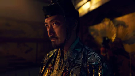 A dramatic HD wallpaper from the TV show Shogun (2024), featuring a character in ornate attire, set against a rich, atmospheric background.